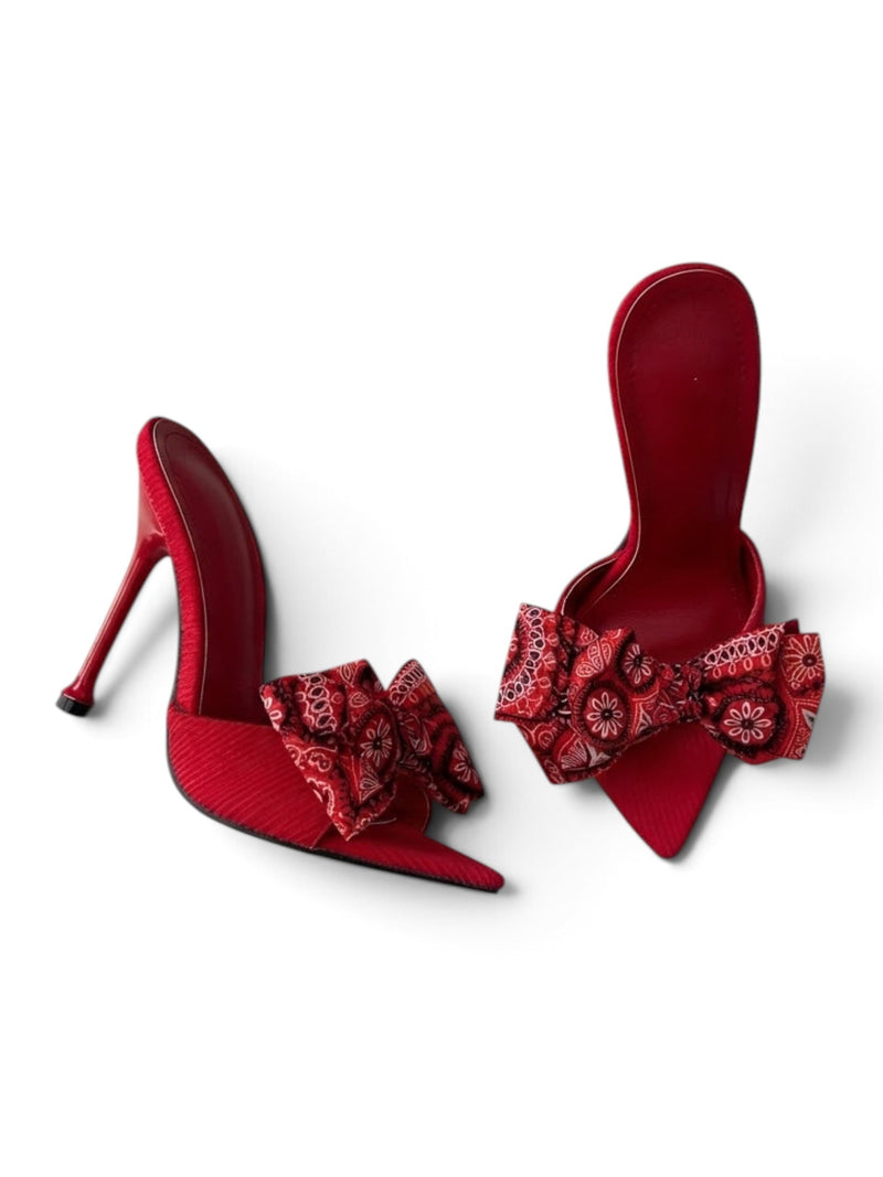 Red bandana paisley print shoe bow clip on red pointed-toe stiletto mules, front angle