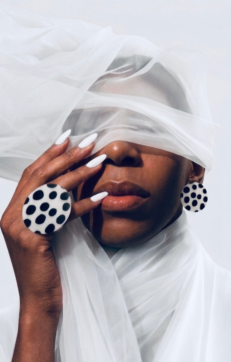 Polka Dot Statement Ring – white with black dots, shown on hand